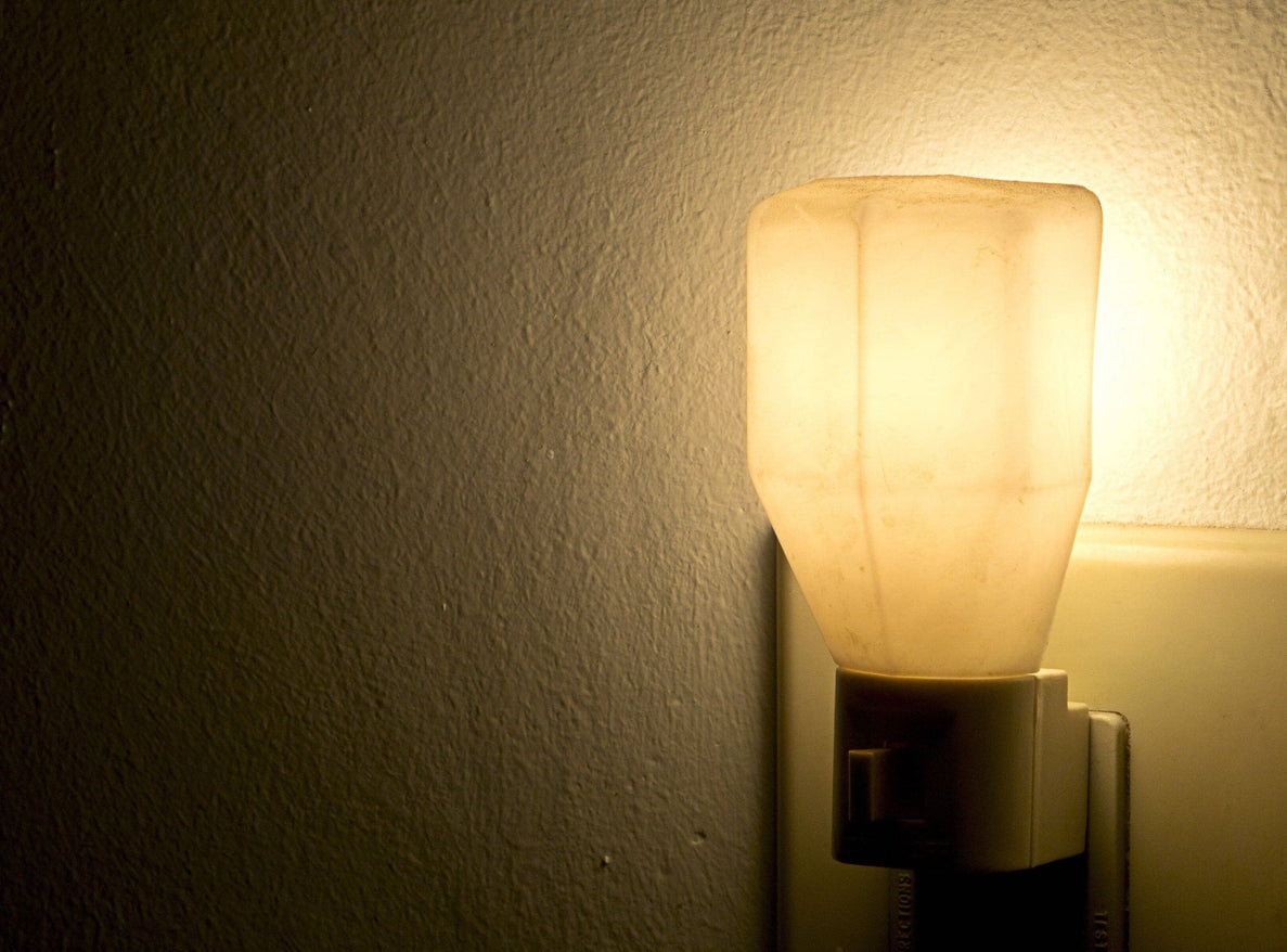 a closeup photo of a nightlight plugged into a wall