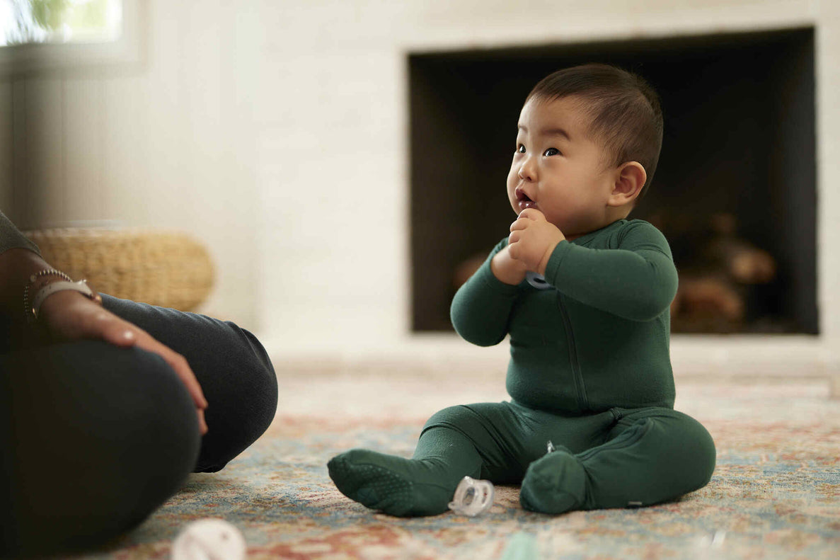 7 month old baby sitting up playing