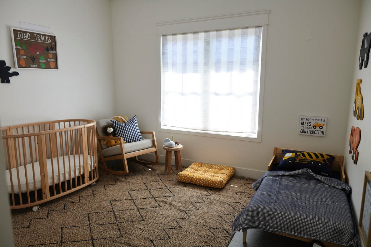 a photo of a child's room with a crib and a toddler bed on opposite sides of the room